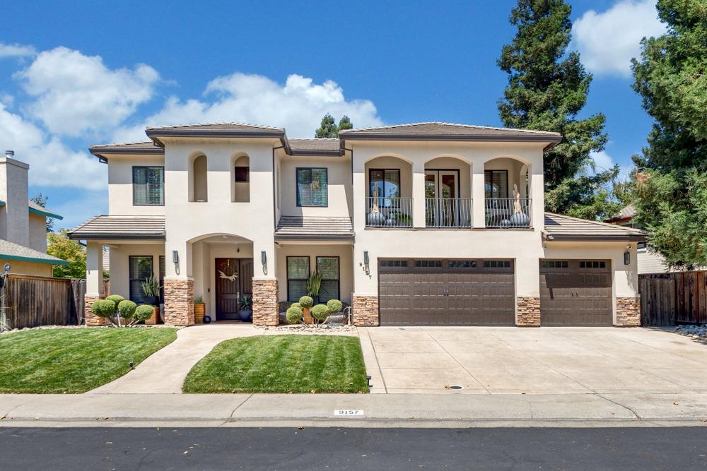 a front view of a house with yard and garage