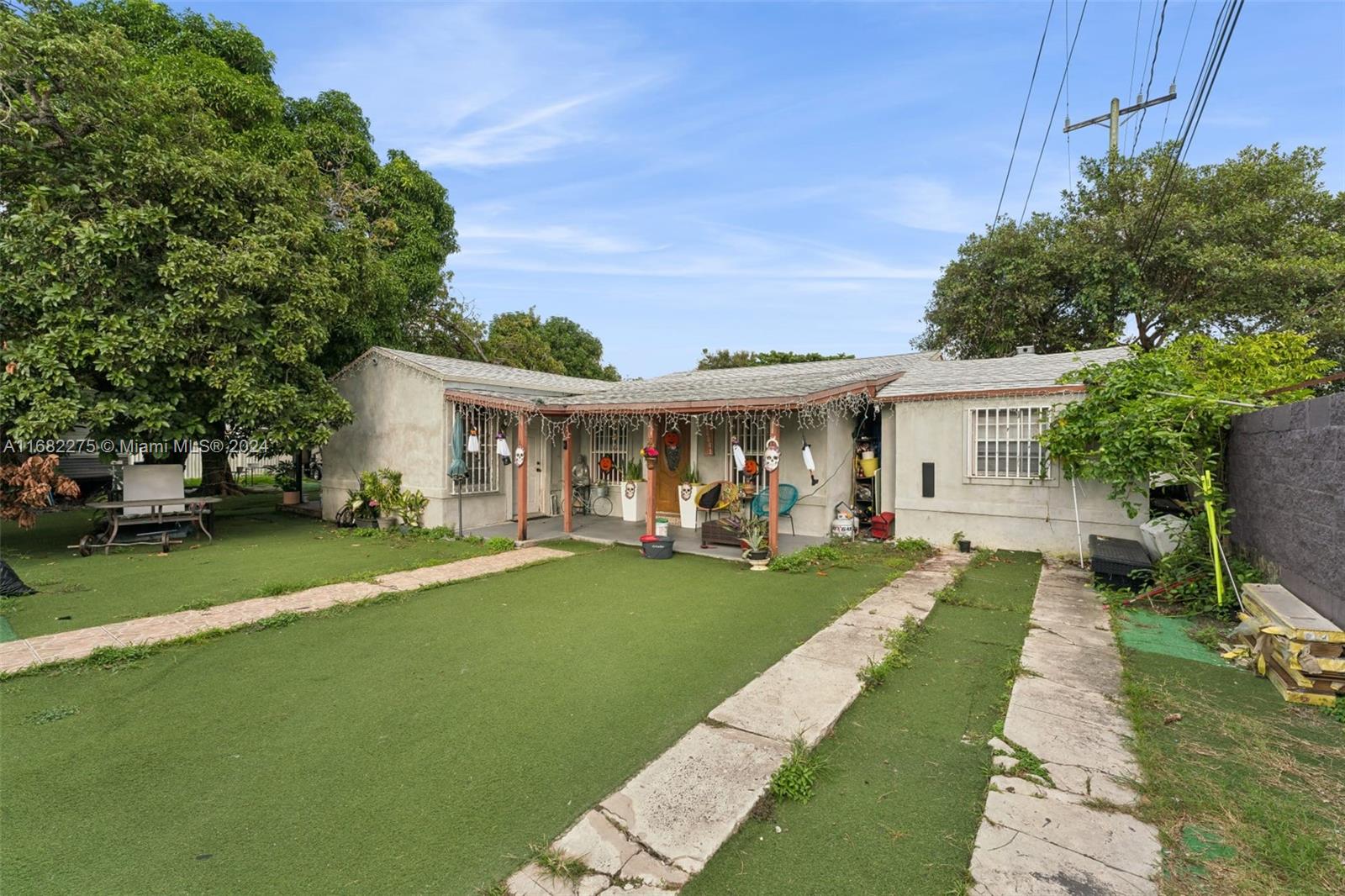 a front view of a house with a garden