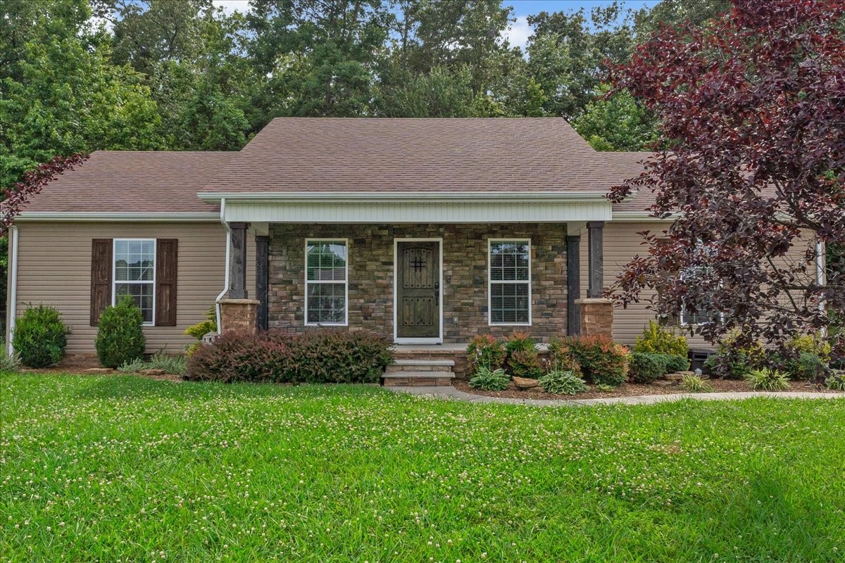 a view of a house with a yard and plants