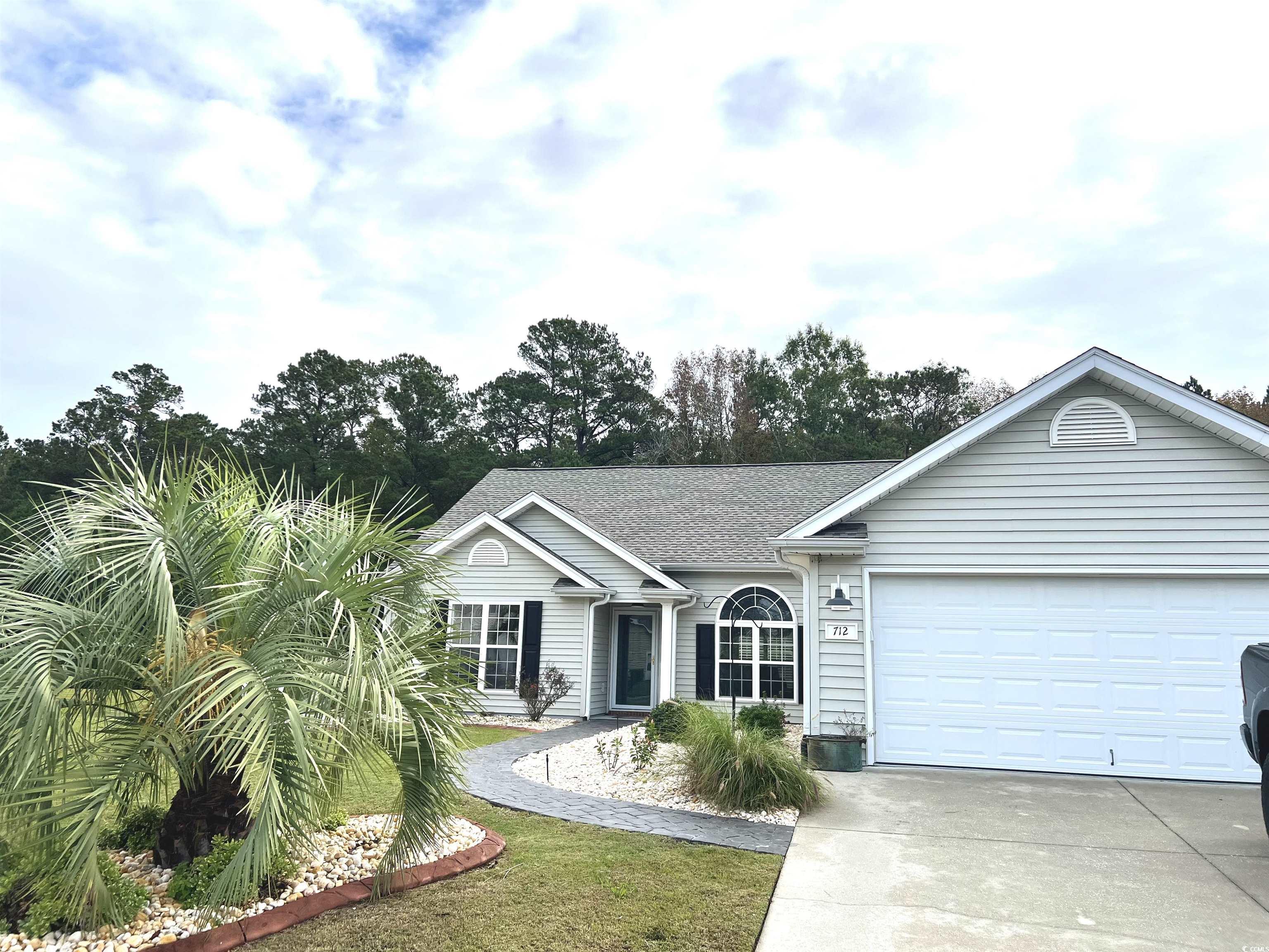 Single story home featuring a garage and a front l