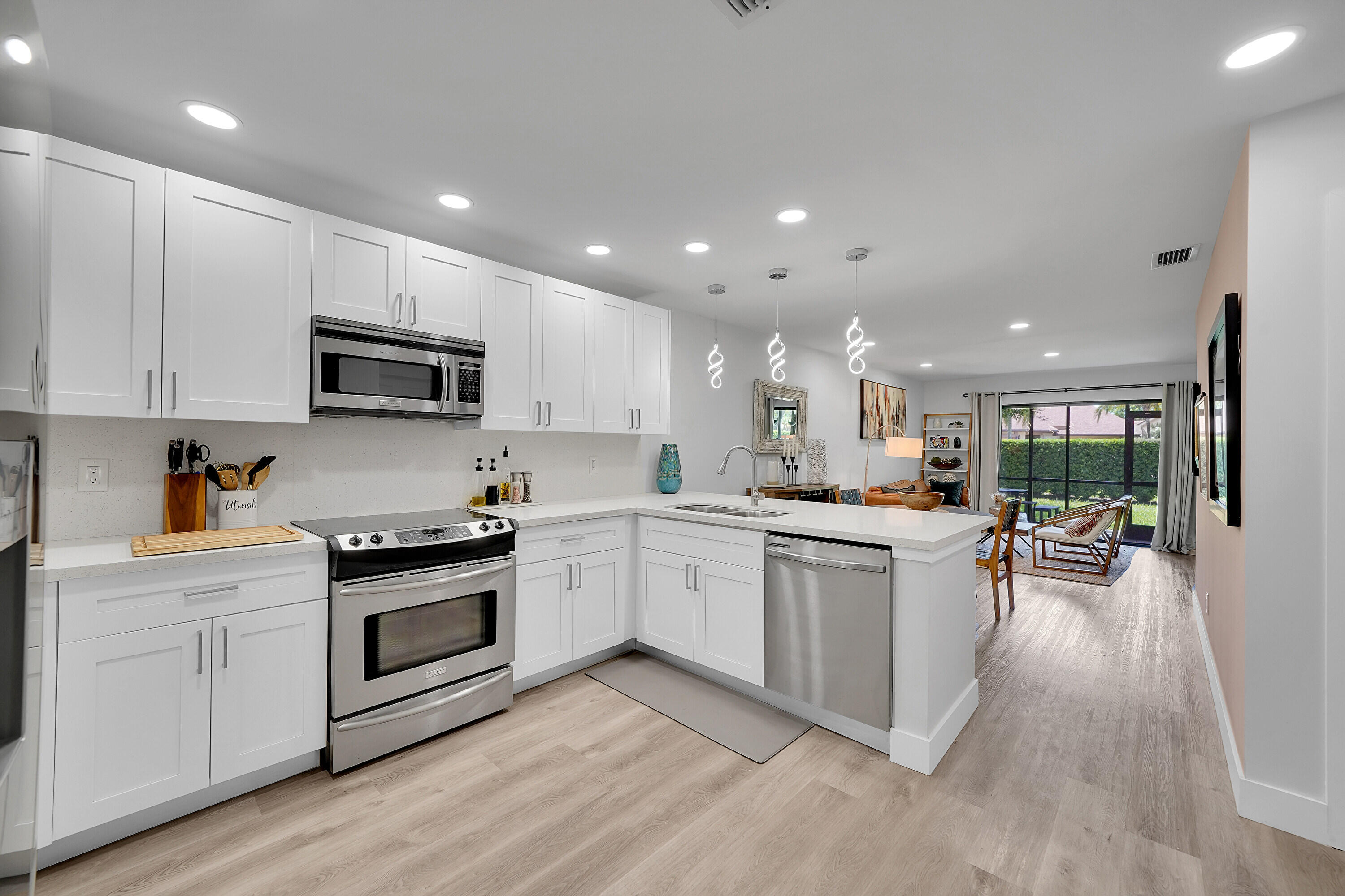 a kitchen with sink a stove and cabinets