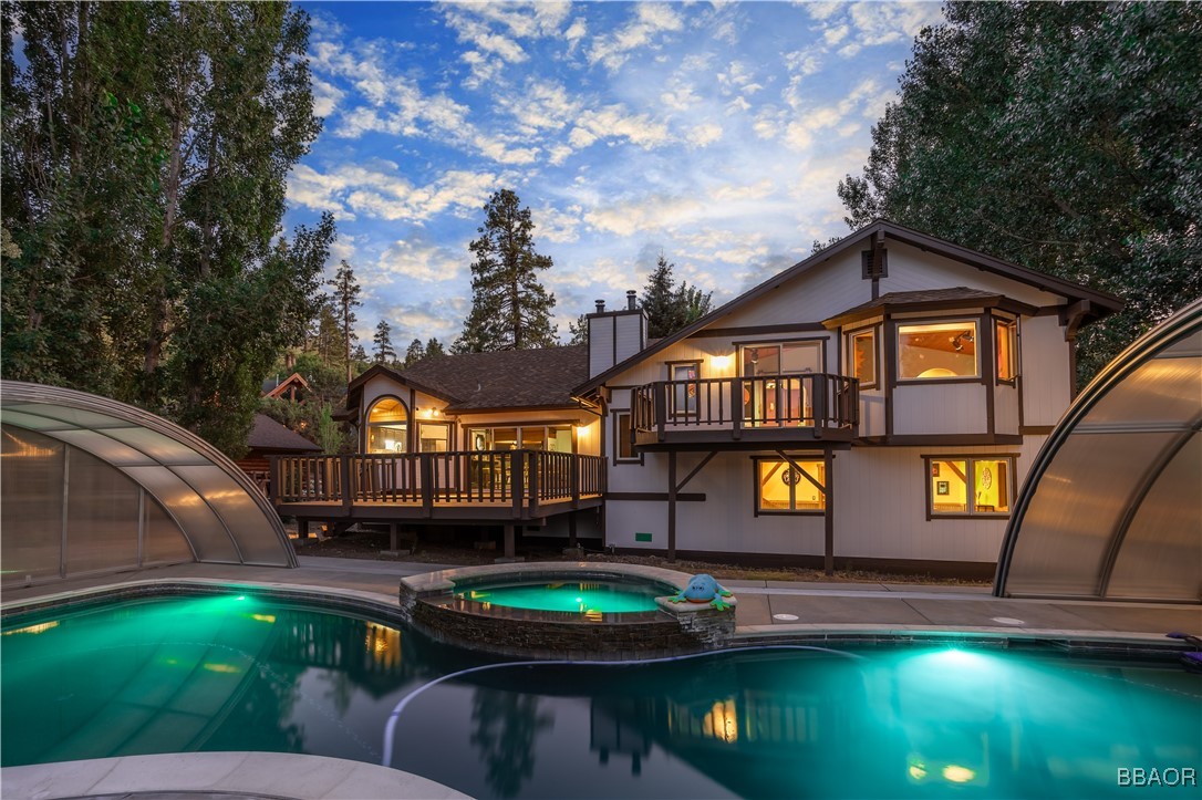 a front view of a house with swimming pool having outdoor seating