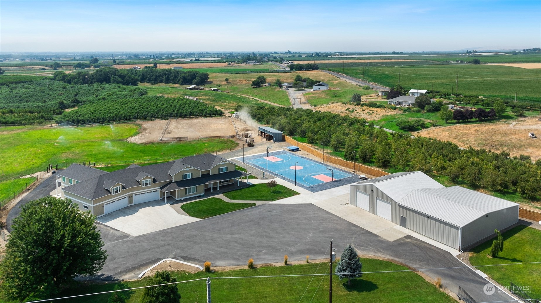 an aerial view of a house with a garden and lake view