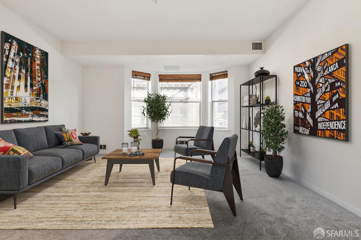 Spacious living room with bay window. Property is virtually staged.