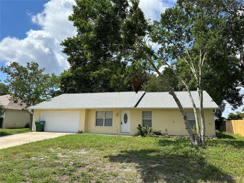 a front view of house with yard and trees