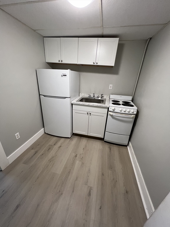 a kitchen with a stove a refrigerator and a fireplace