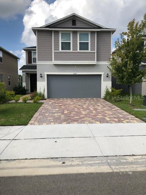 a front view of a house with a yard and garage