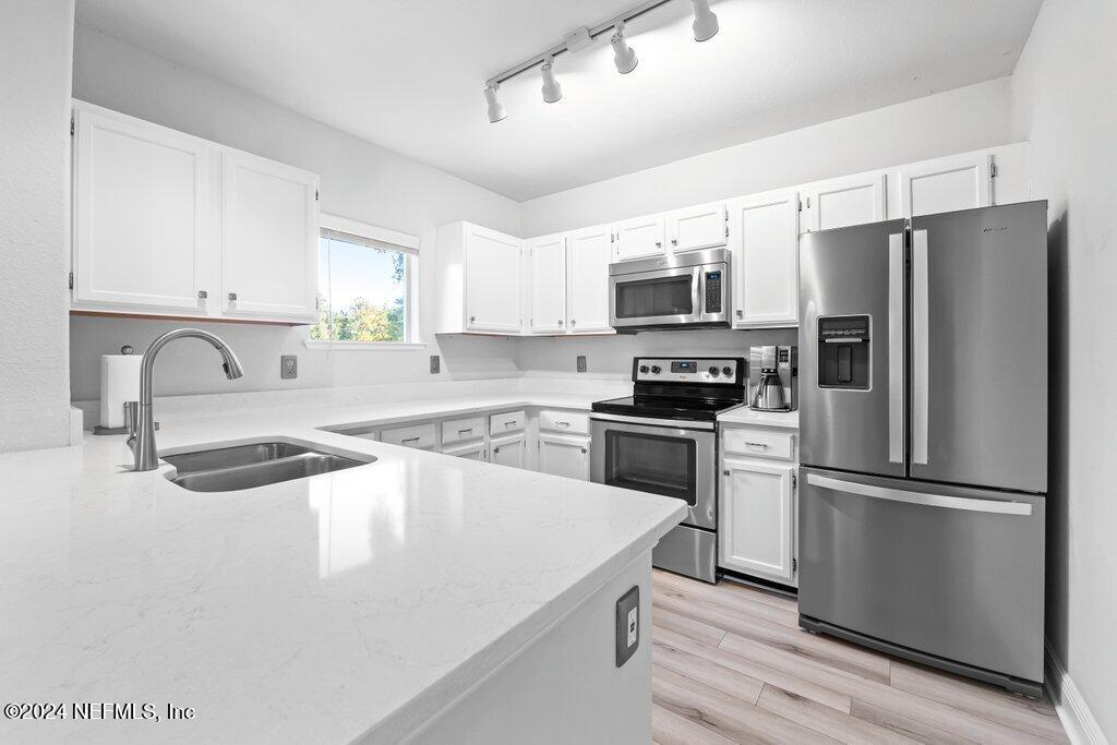 a kitchen with a refrigerator sink and microwave