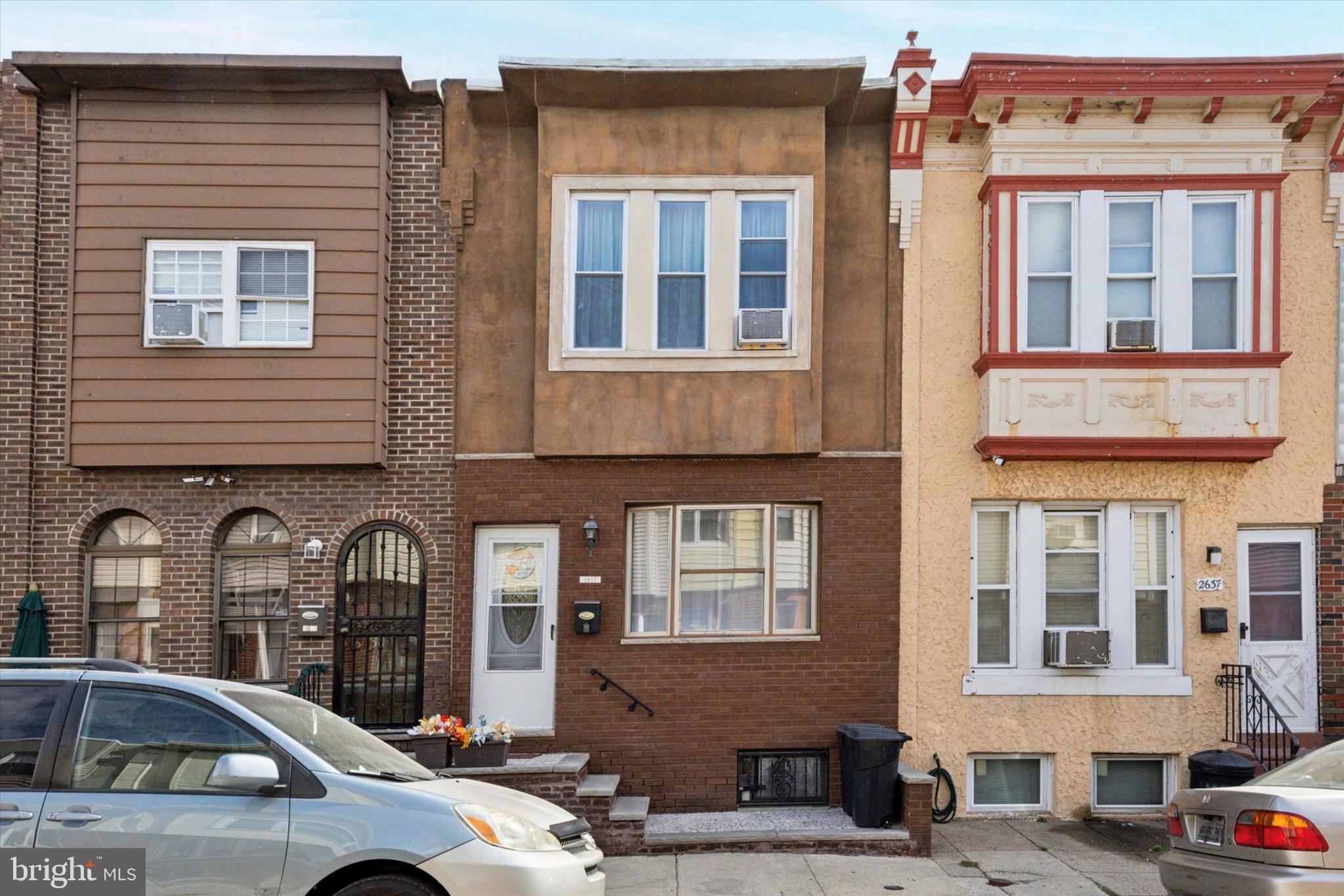 a front view of a residential apartment building with a yard