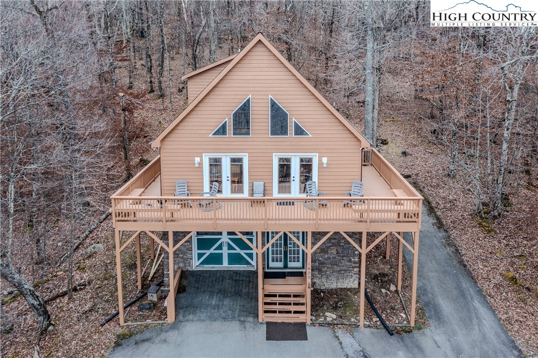 a view of a wooden deck and a backyard