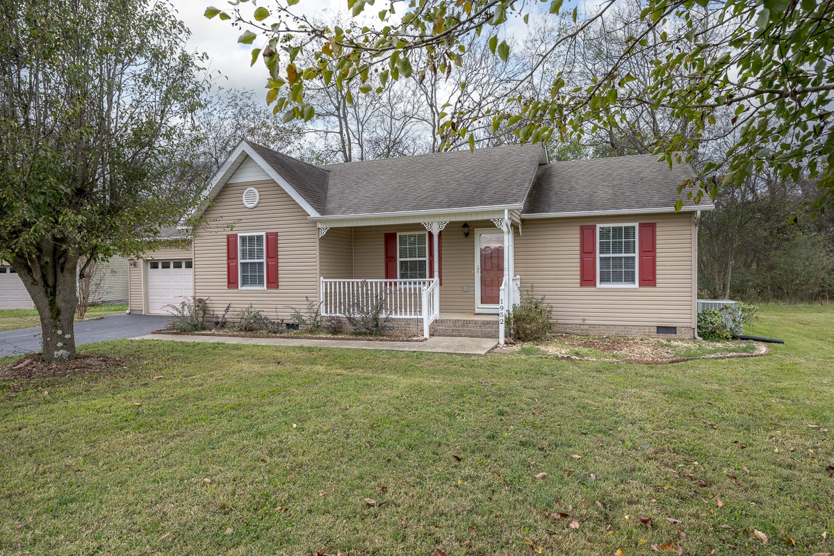 a front view of house with yard and trees