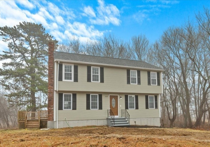 a front view of a house with a yard