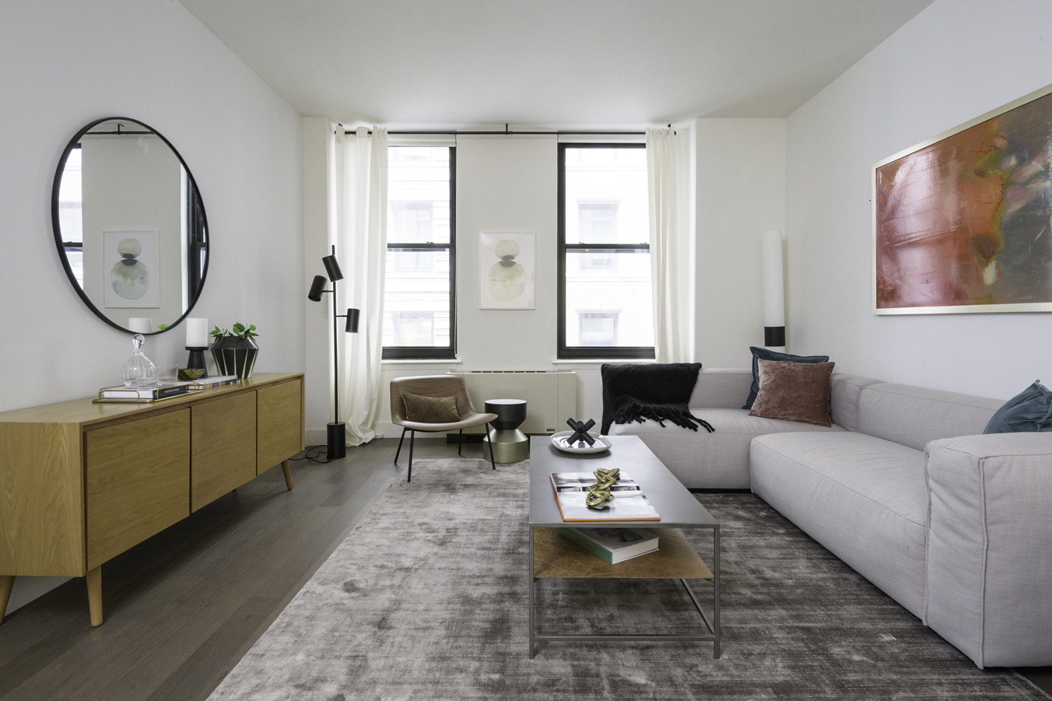 a living room with furniture a window and a potted plant