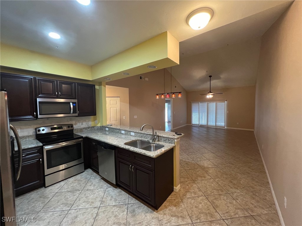 a kitchen with stainless steel appliances granite countertop a stove and a sink