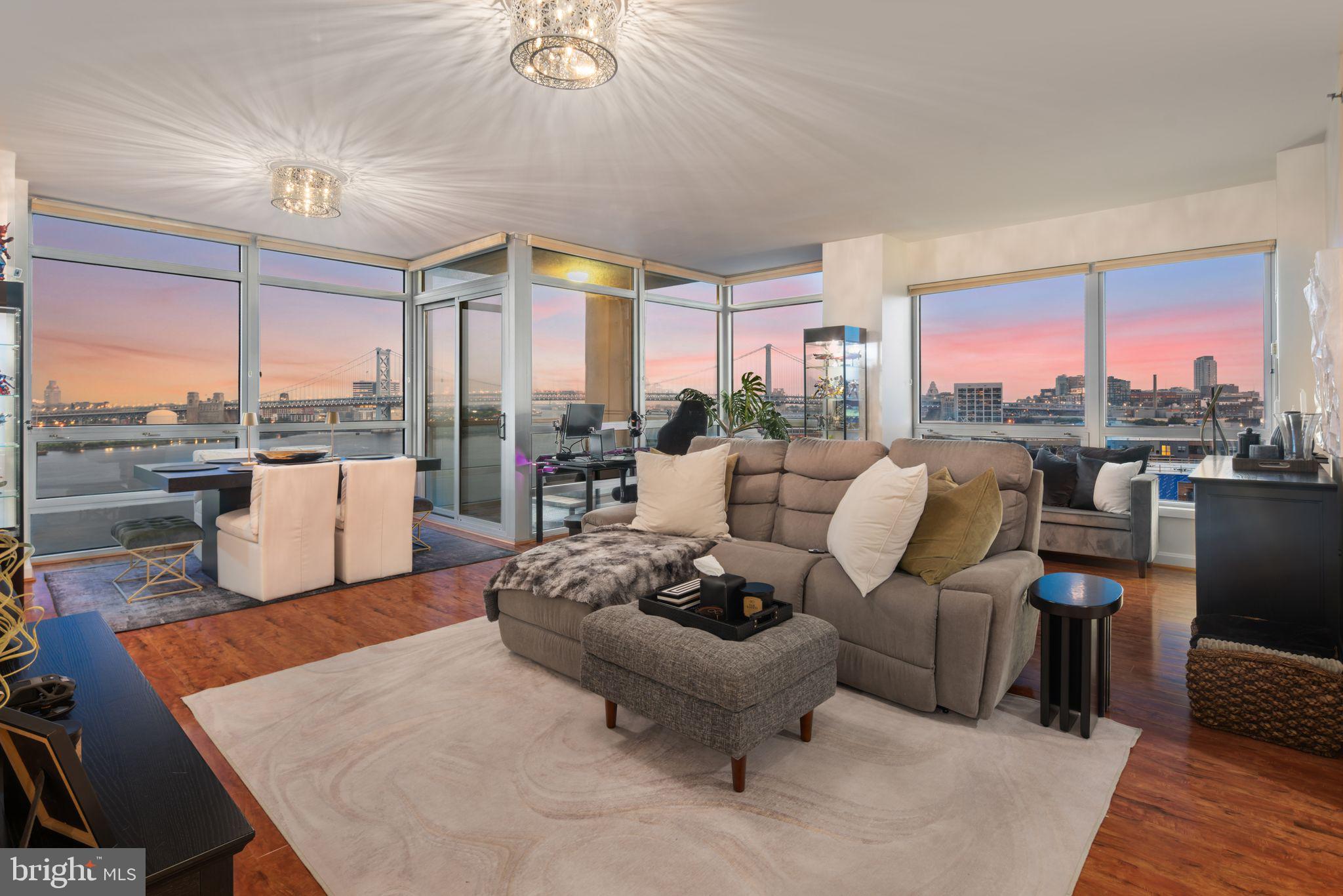 a living room with furniture and a floor to ceiling window