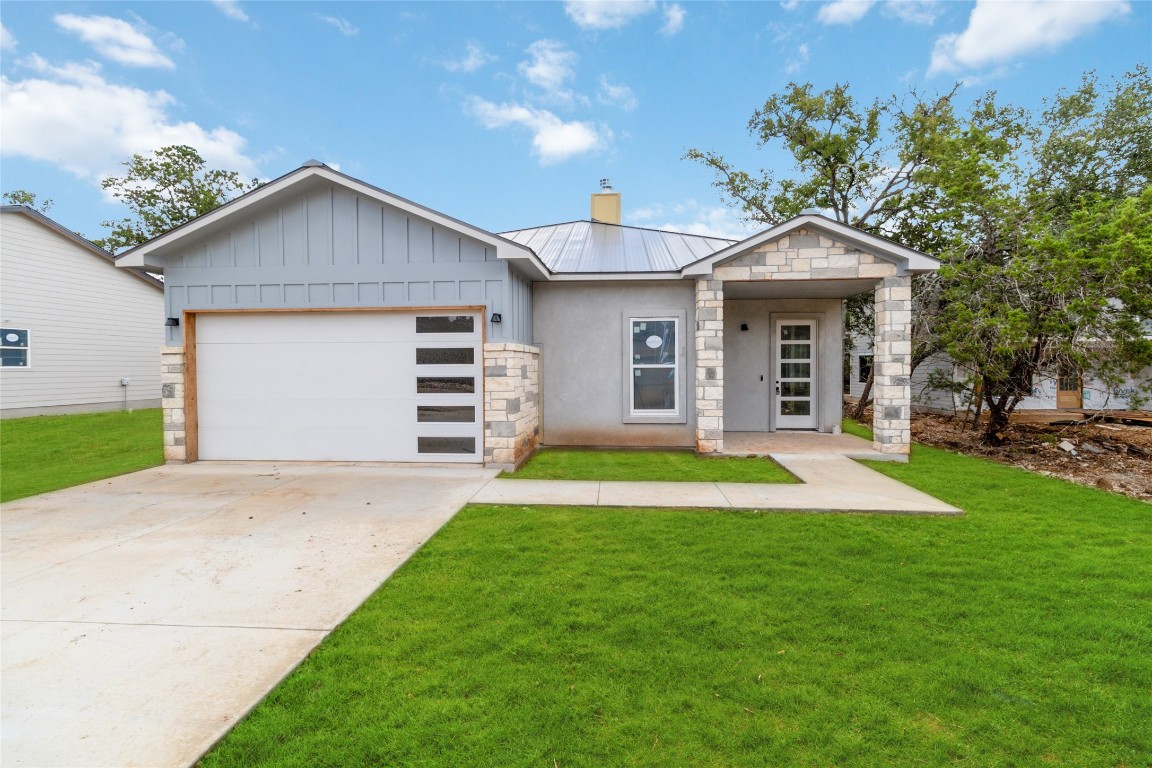 a view of a house with a yard and garage