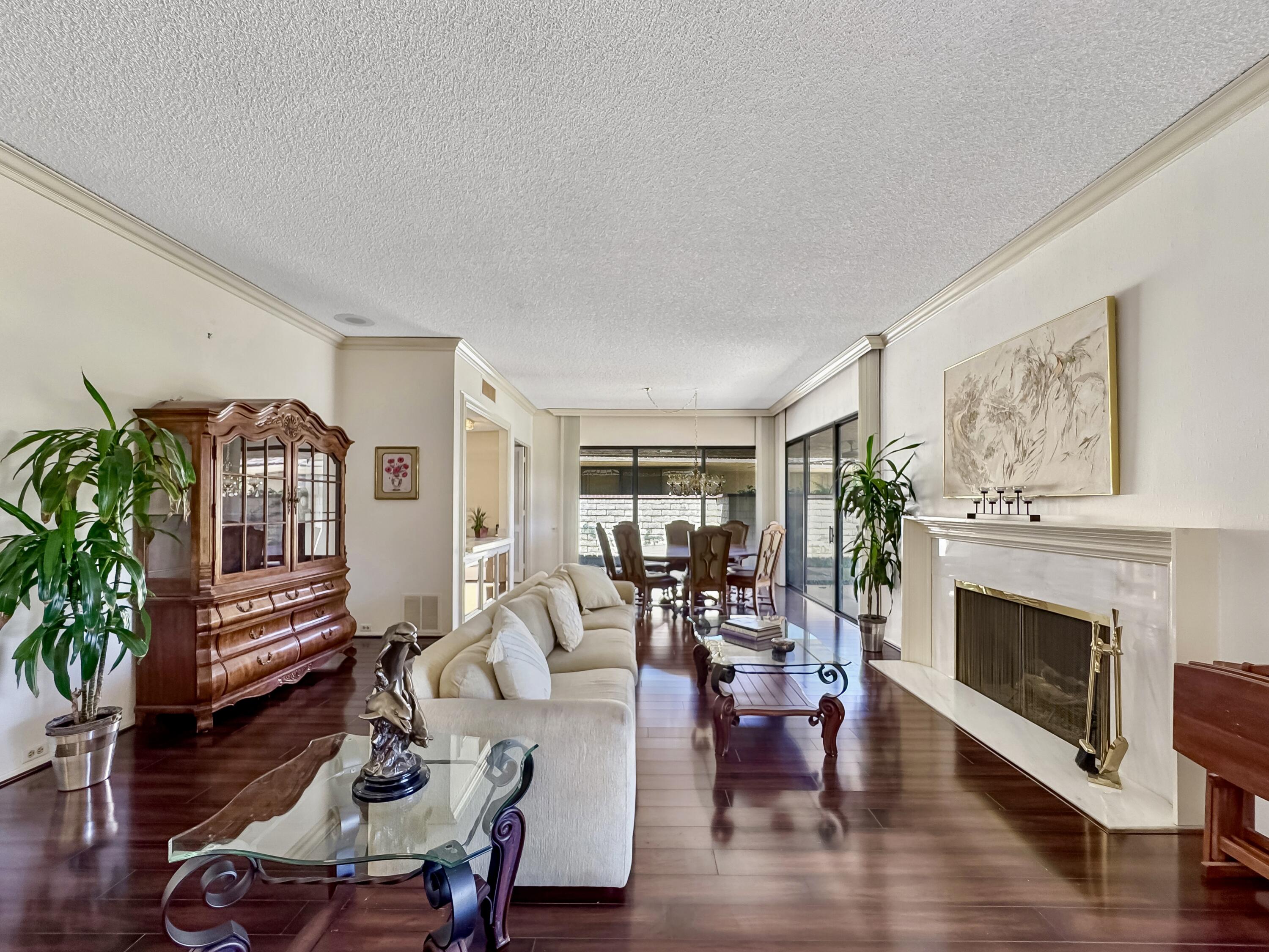 a living room with furniture a fireplace and wooden floor