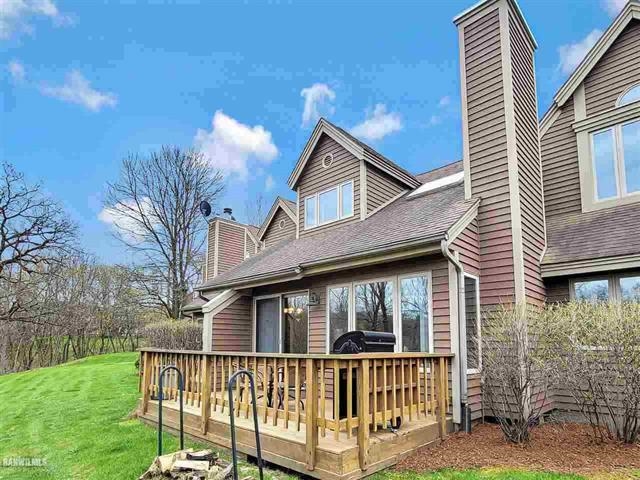 a view of a house with a yard and deck