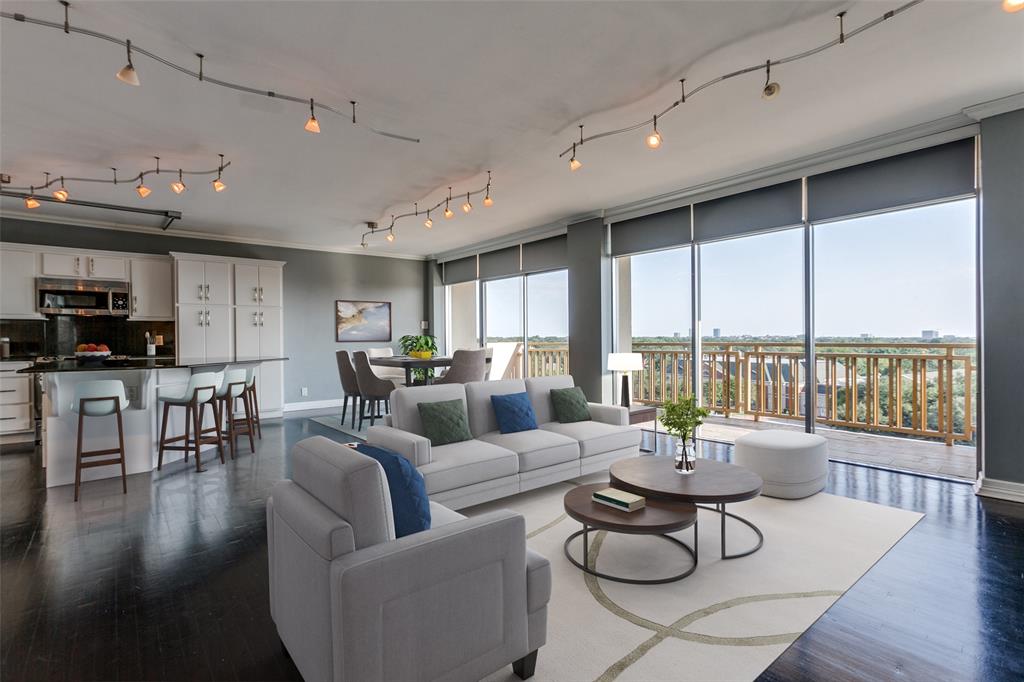 a living room with furniture wooden floor and a floor to ceiling window