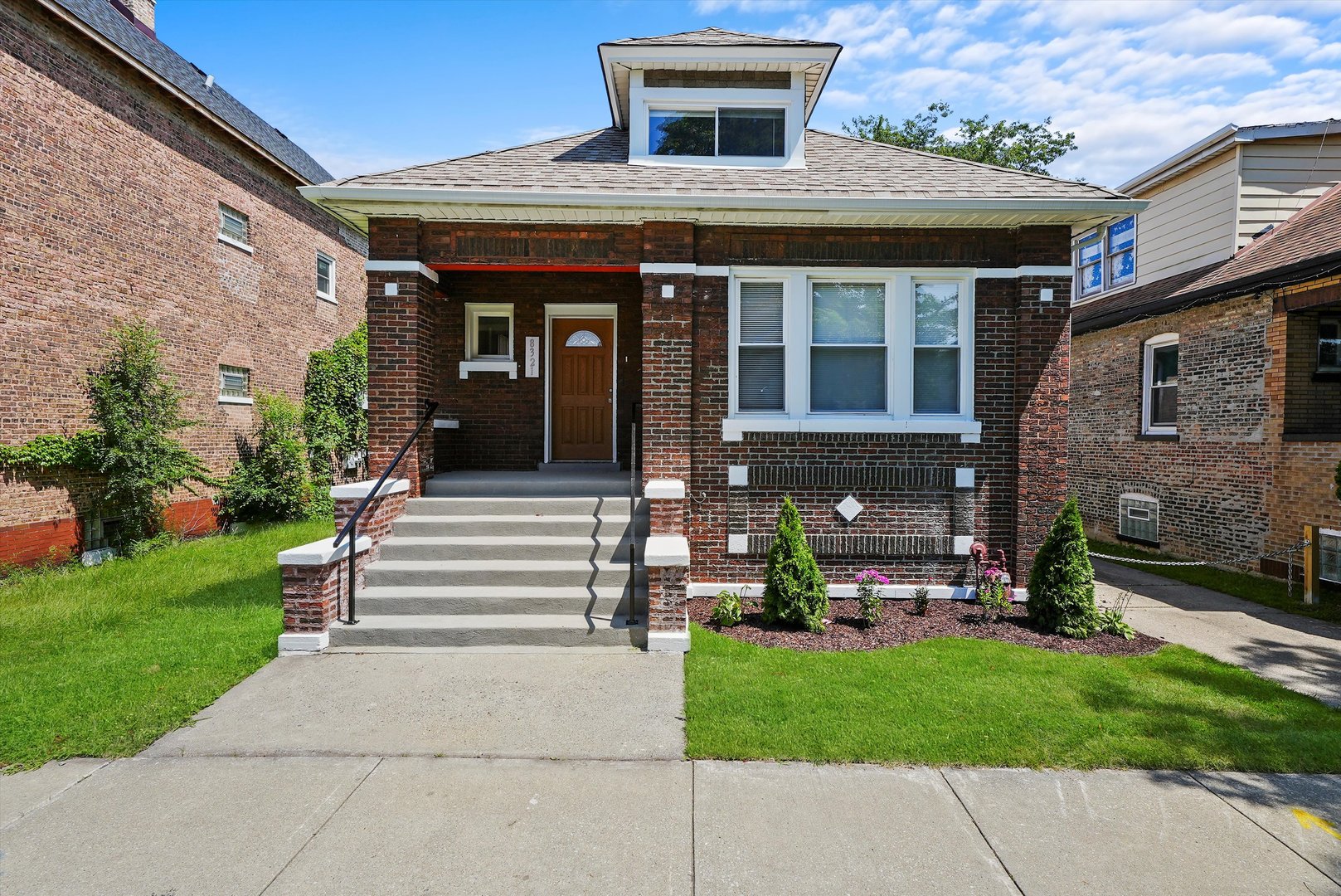 a front view of a house with a garden