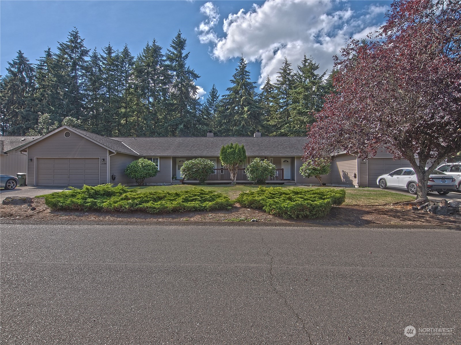 a front view of a house with a yard and a garage