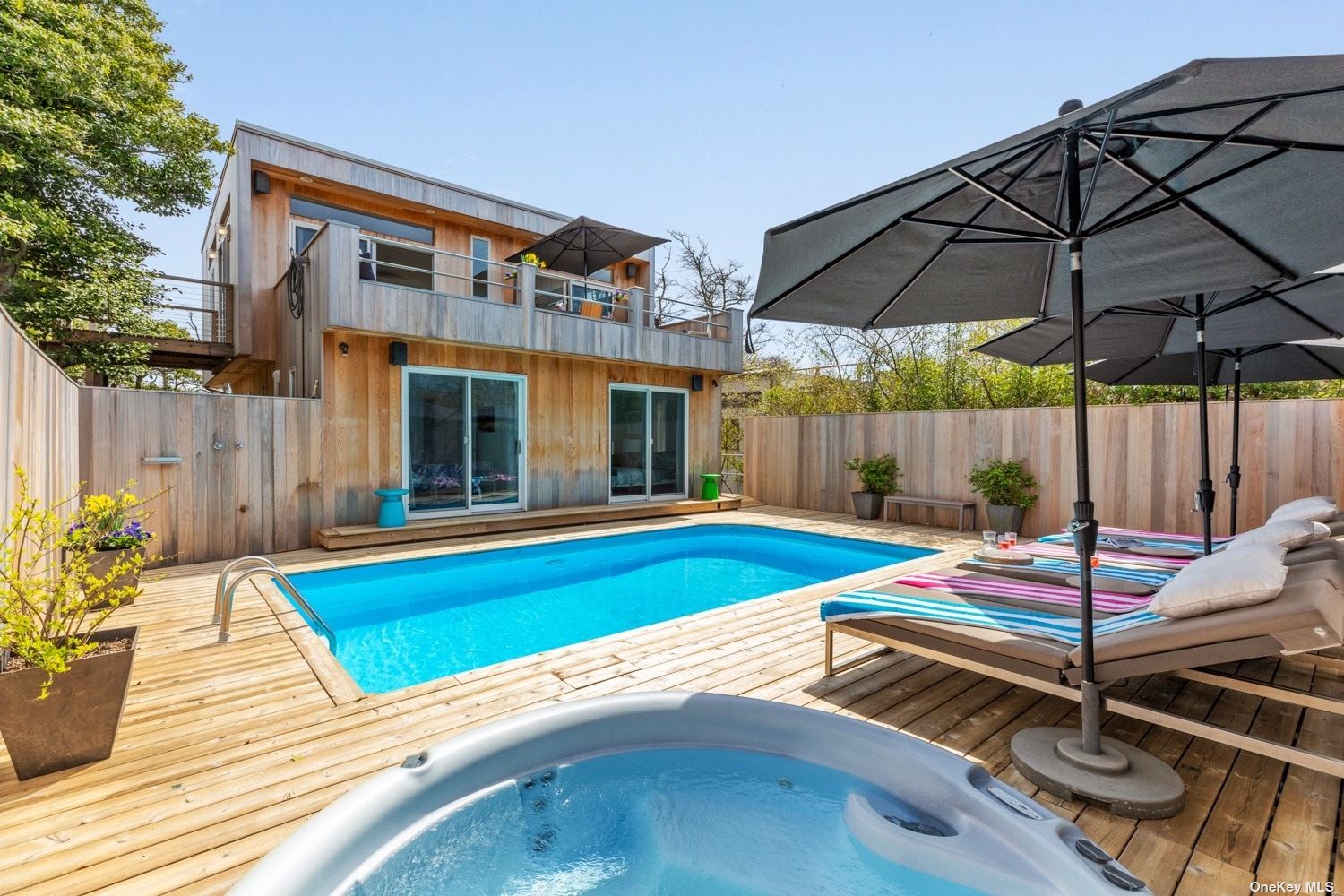 a view of a backyard with a patio and swimming pool