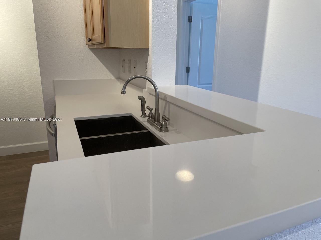 a kitchen with a sink and cabinets