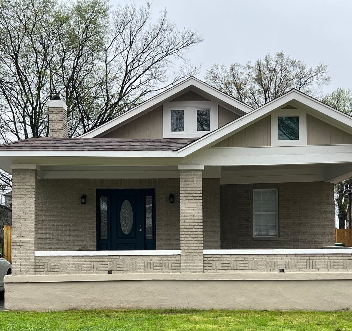 a view of a house with a large window and a yard