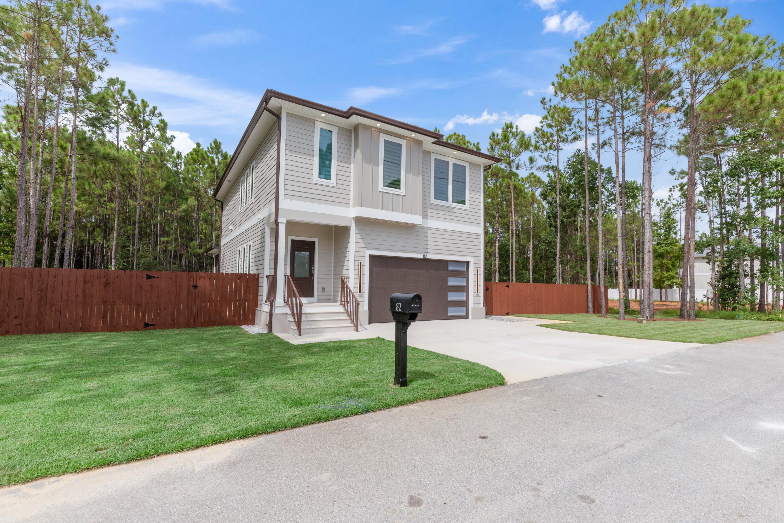 a front view of a house with yard and green space