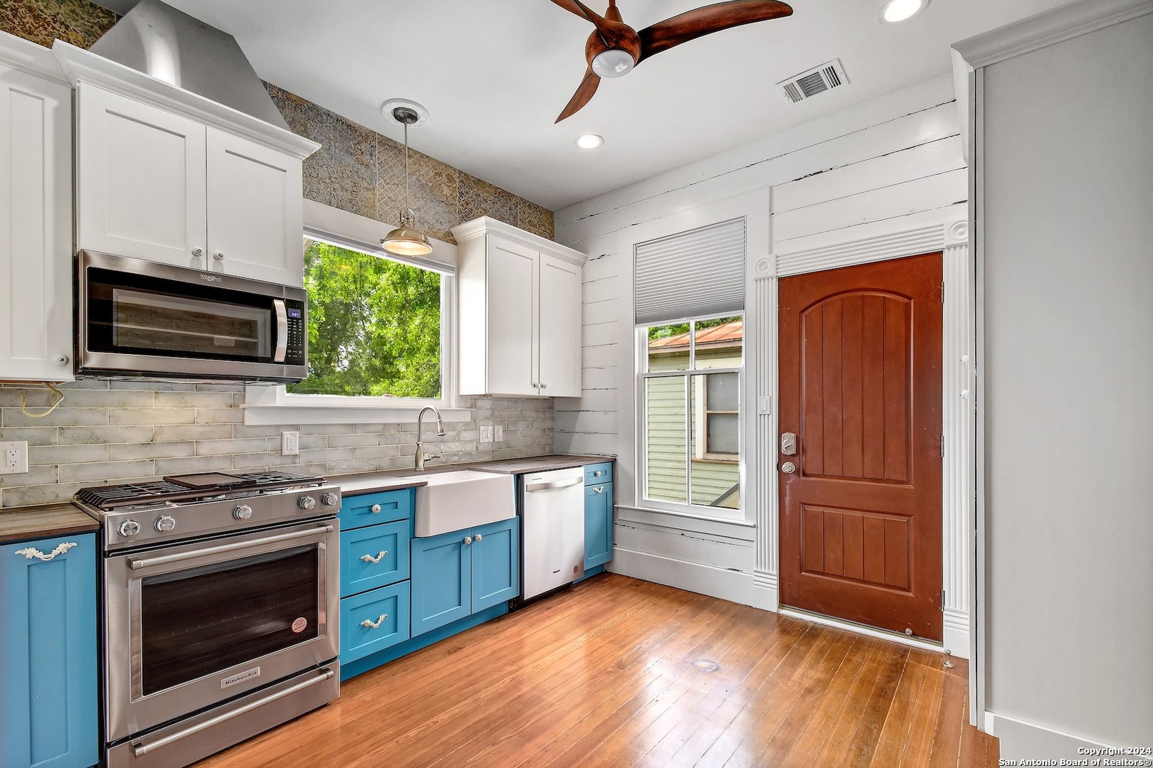 a kitchen with stainless steel appliances granite countertop a stove and a refrigerator