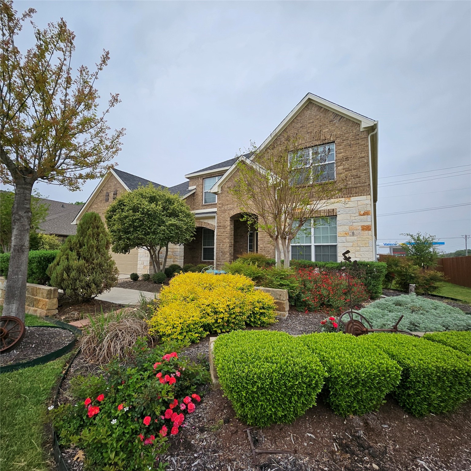 a front view of a house with a yard and plants