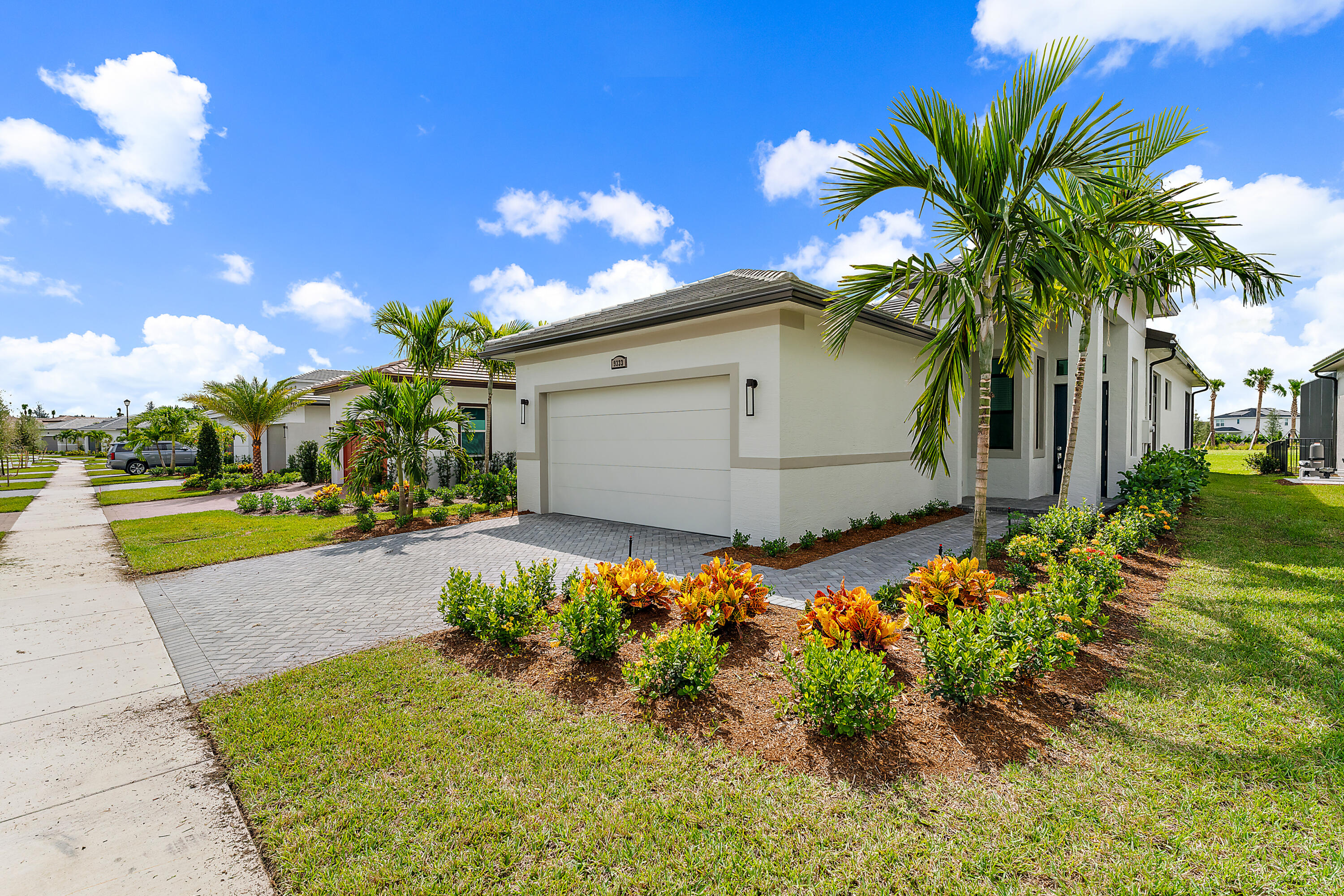 a front view of a house with a yard and a garage