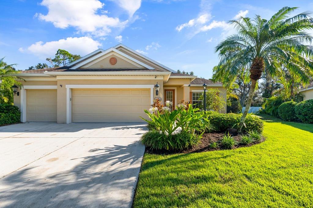 a view of a house with a yard and plants