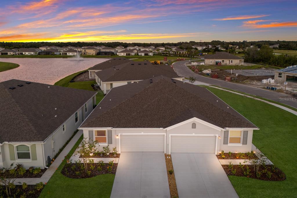 an aerial view of a house with a yard swimming pool and outdoor seating