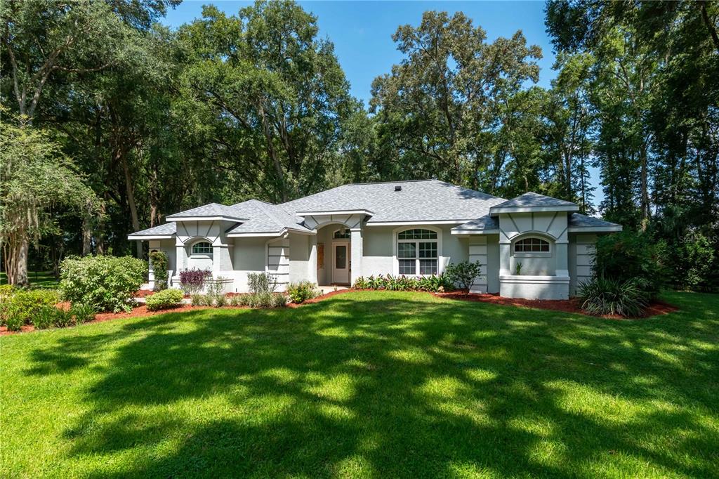 a front view of a house with a garden