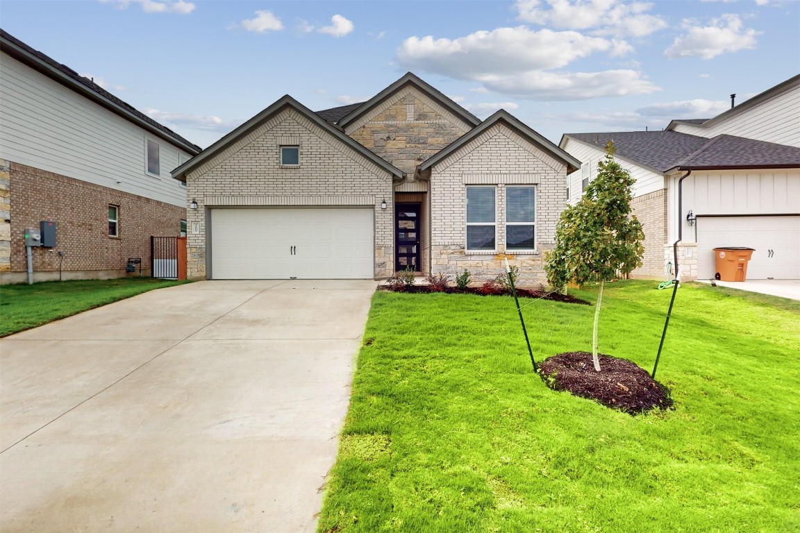 a view of a house with a yard and a garden