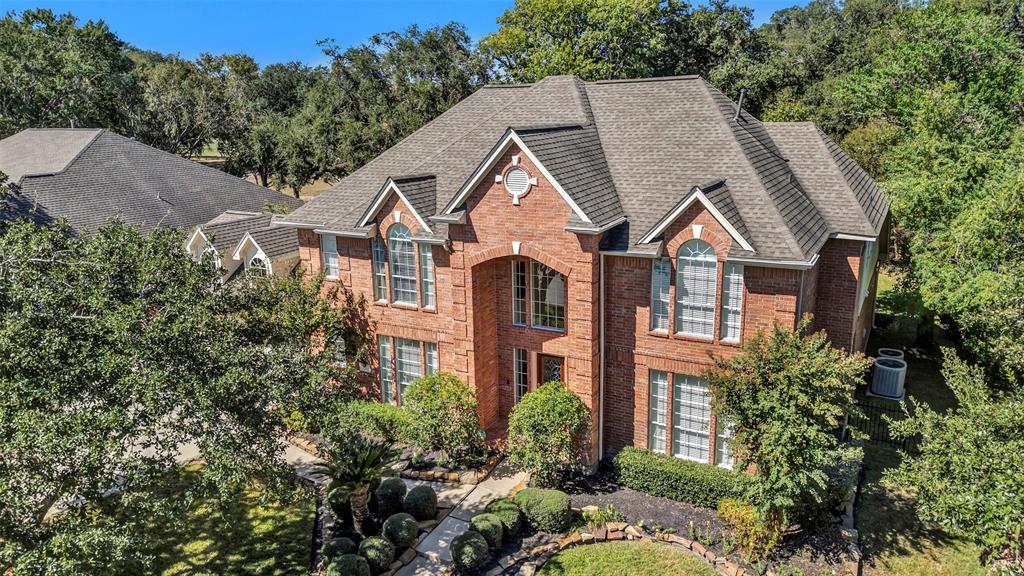 a aerial view of a house next to a yard