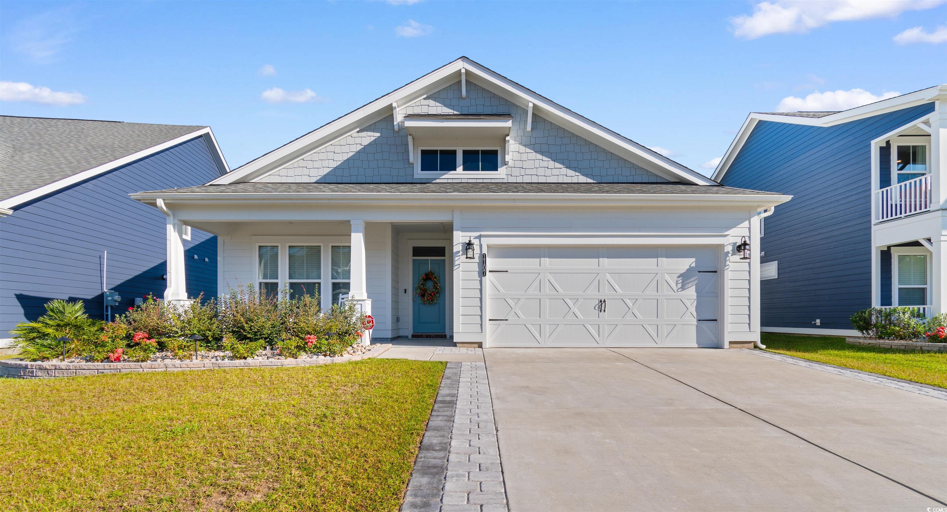 View of front of house featuring a garage and a fr