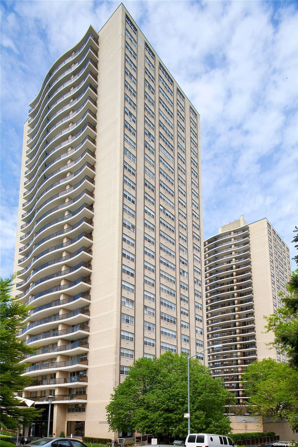 a front view of a building with plants