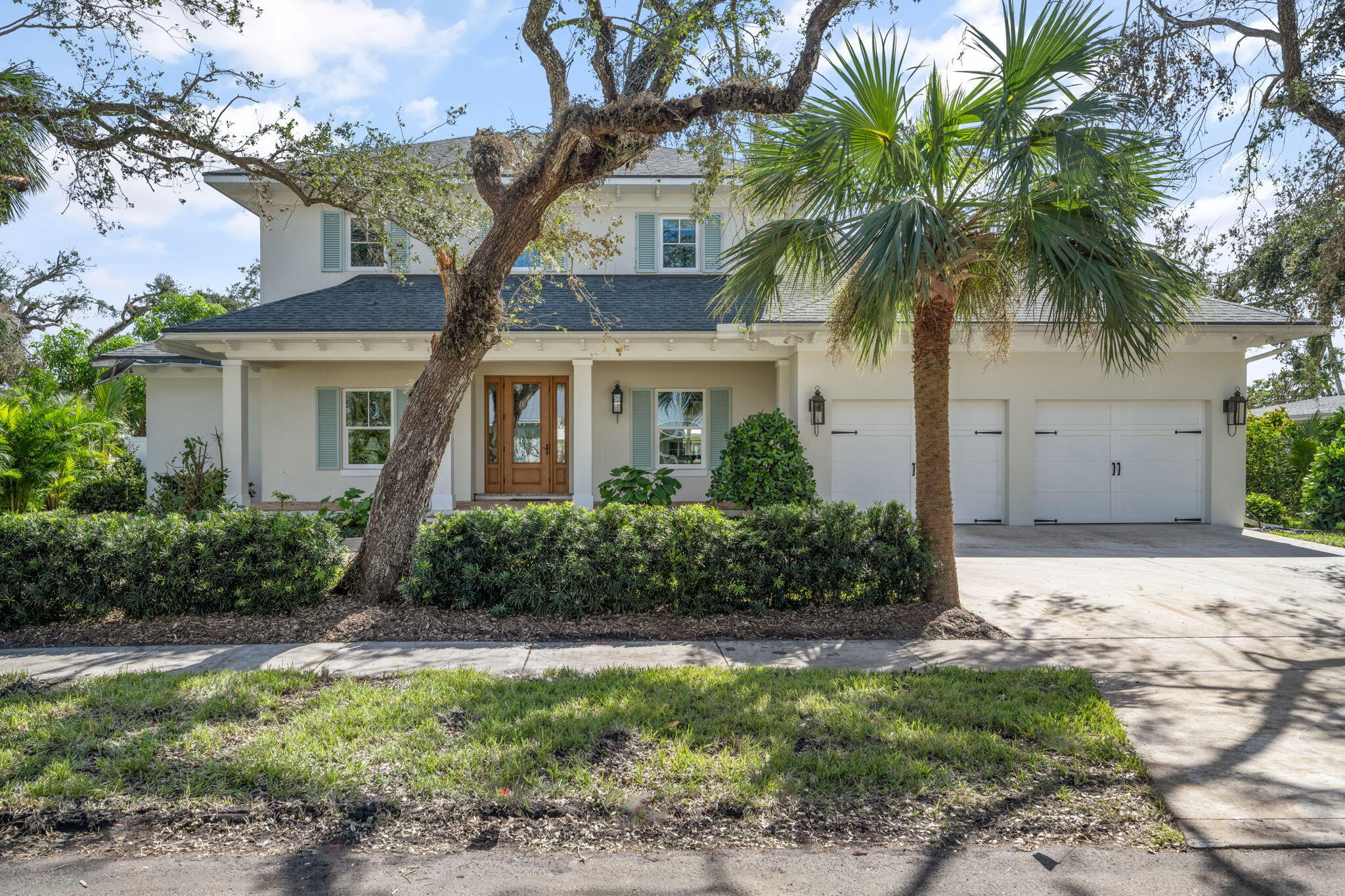 a front view of house with yard and green space