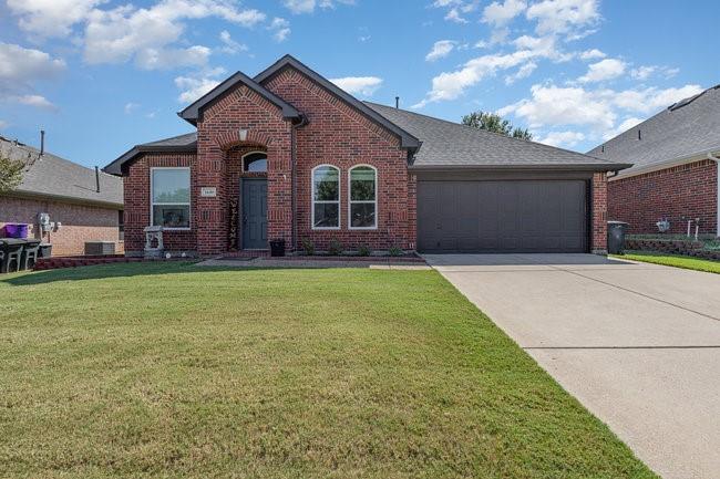 a front view of house with yard and green space