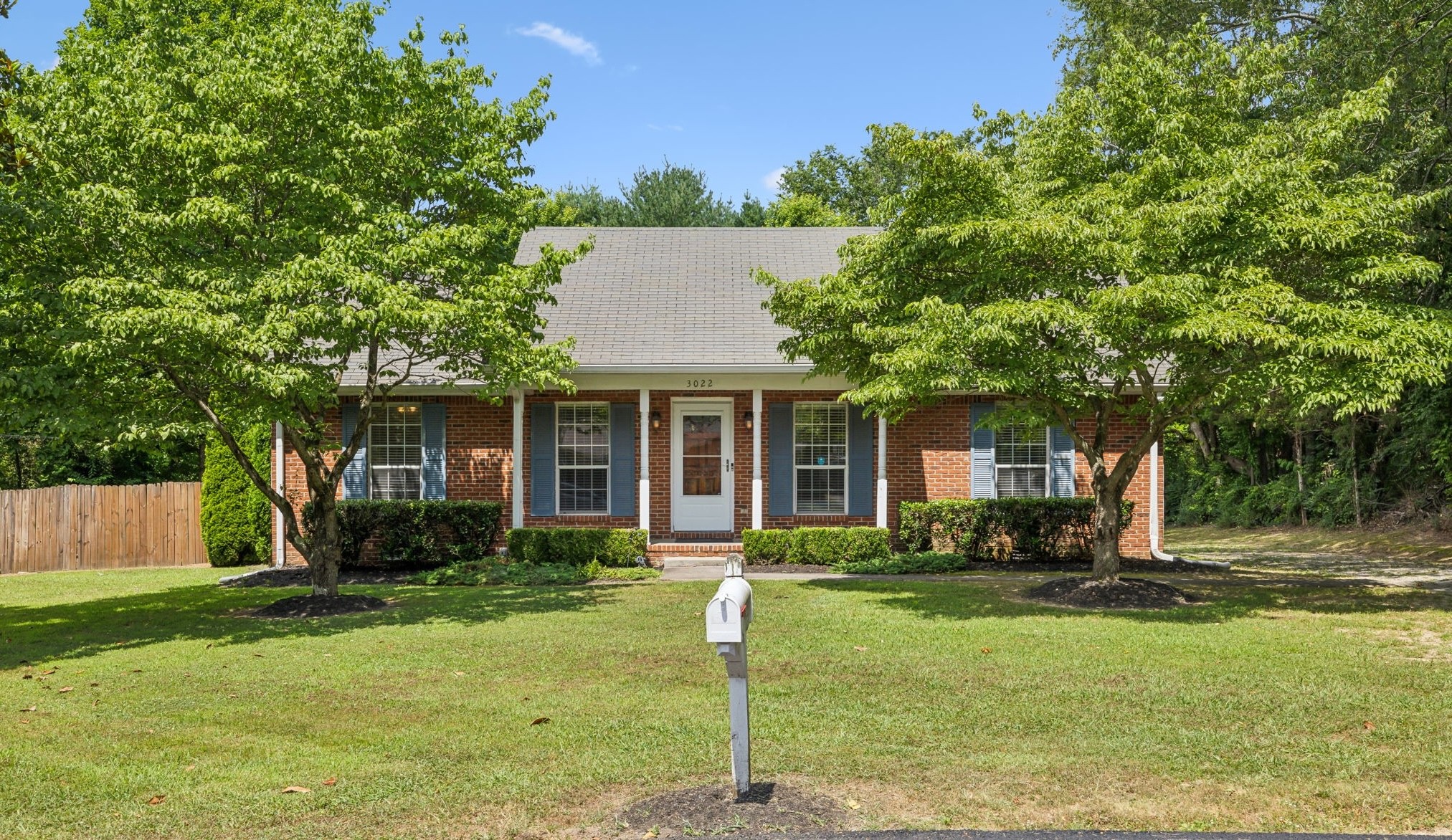 a front view of house with yard and green space