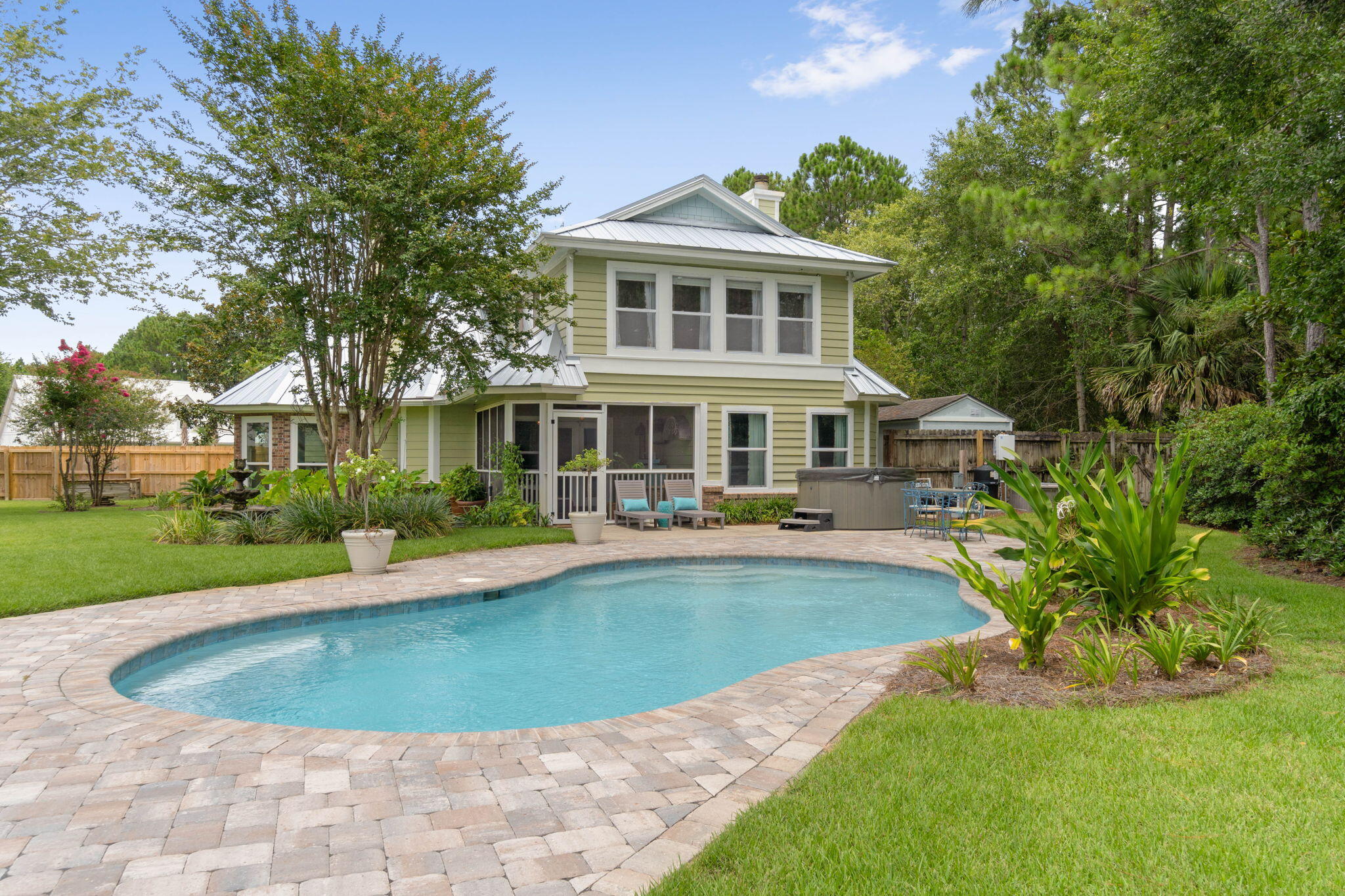 a view of a house with swimming pool and sitting area