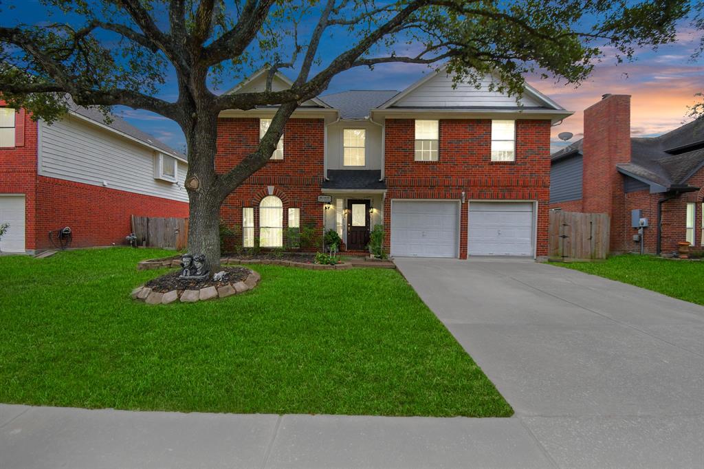 a view of a brick house with a yard