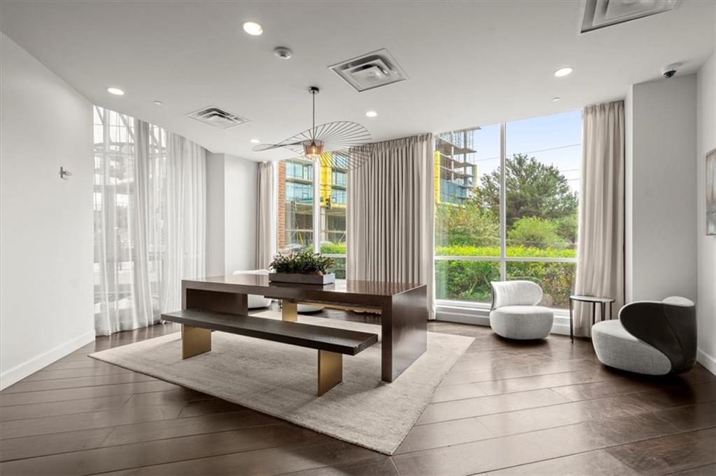 a living room with furniture and large windows