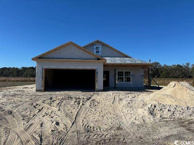 Property under construction featuring a garage