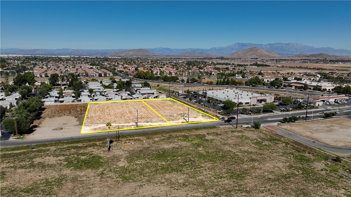 an aerial view of a houses with a yard and lake view