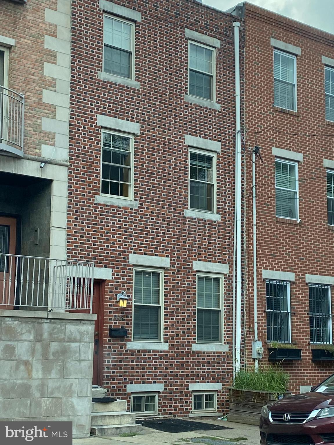 a front view of a house with lots of windows