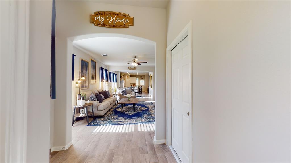 a view of living room filled with furniture and wooden floor