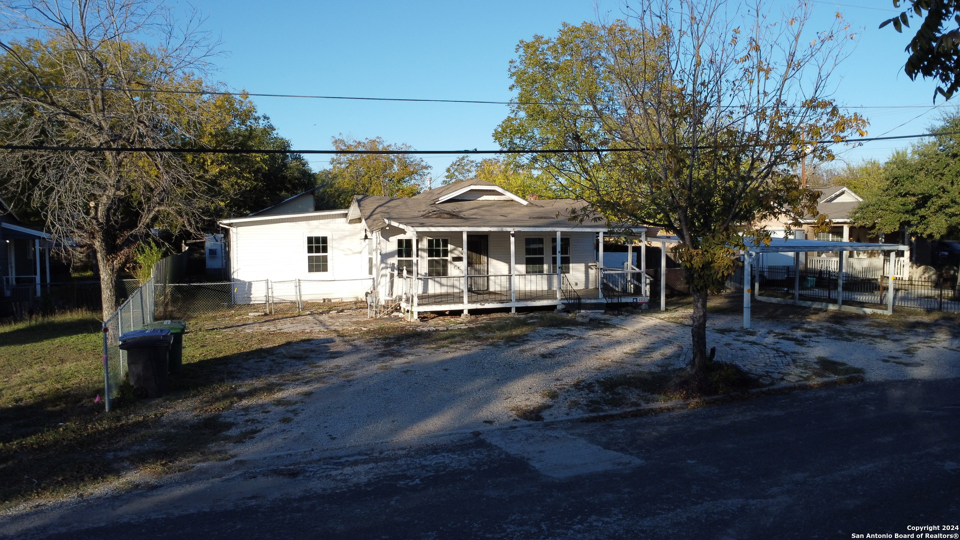 a view of a large house with a yard and sitting area